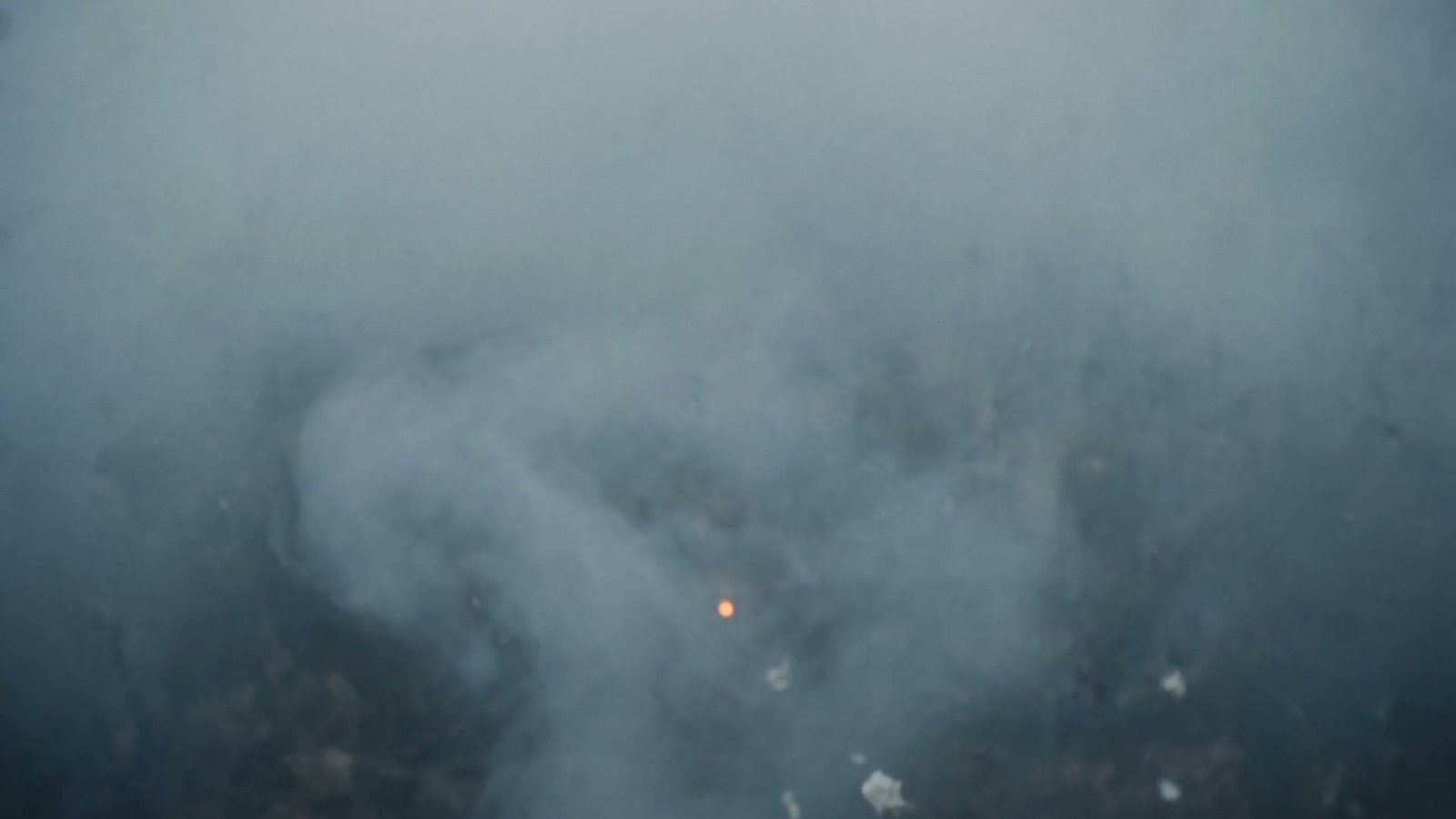 The settled ember of light resting in calm fog
